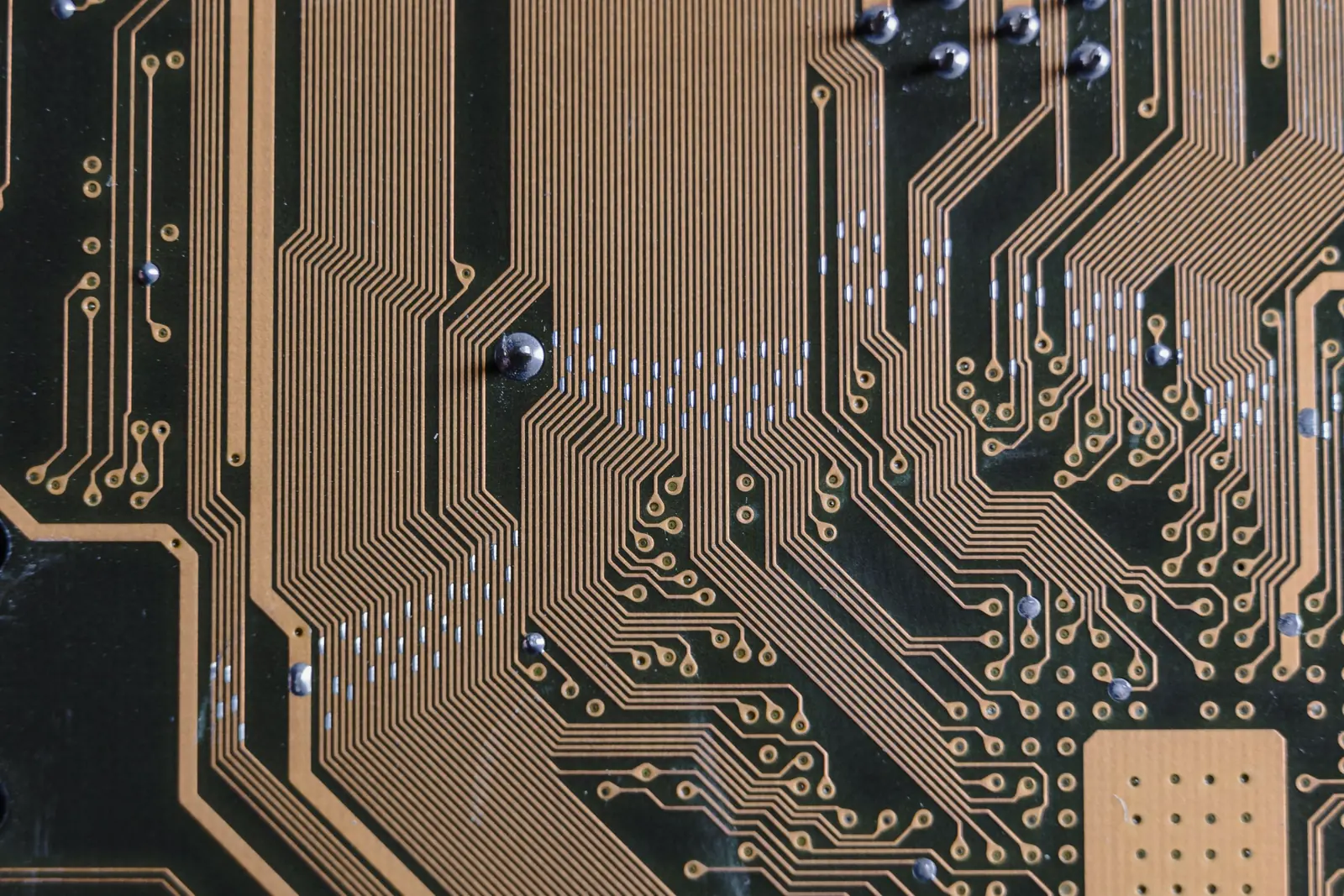 Close-up of a circuit board with fine gold traces.
