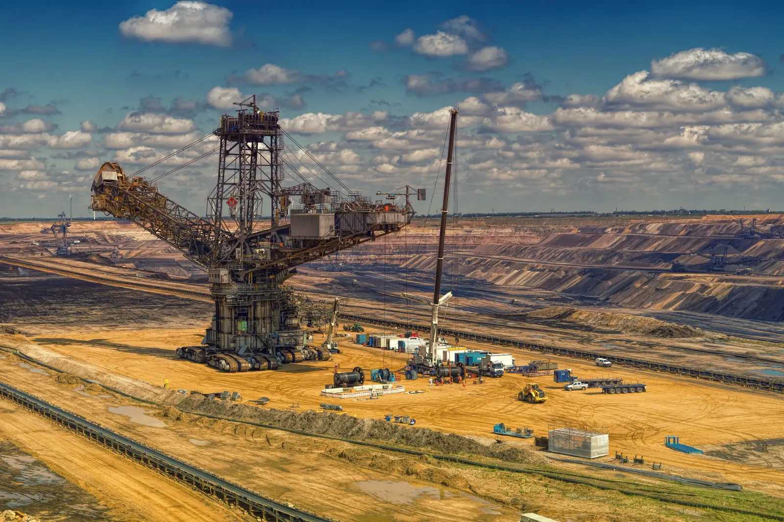 A bucket-wheel excavator in a sun-baked open-pit mine.