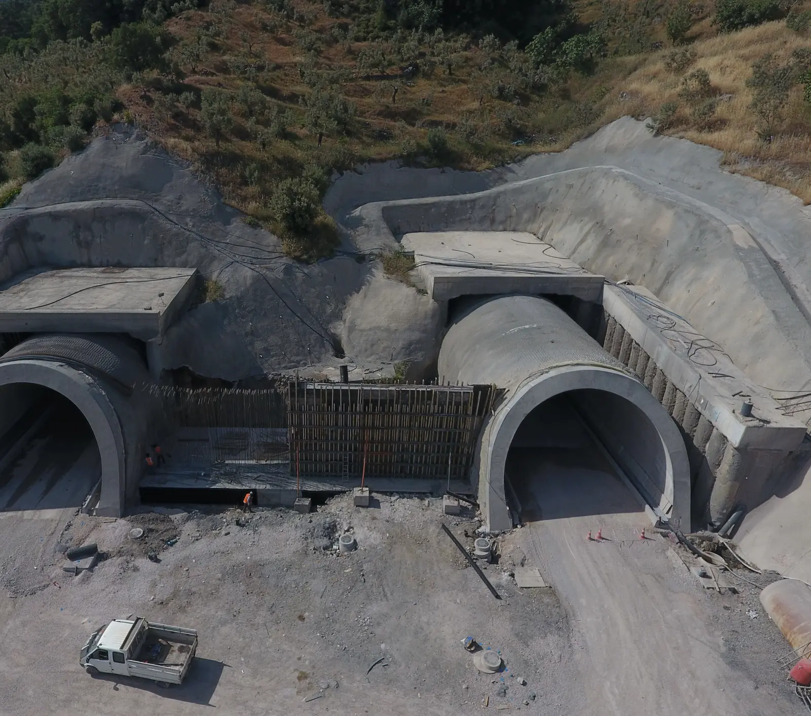 Aerial view of two tunnel portals on a construction site.